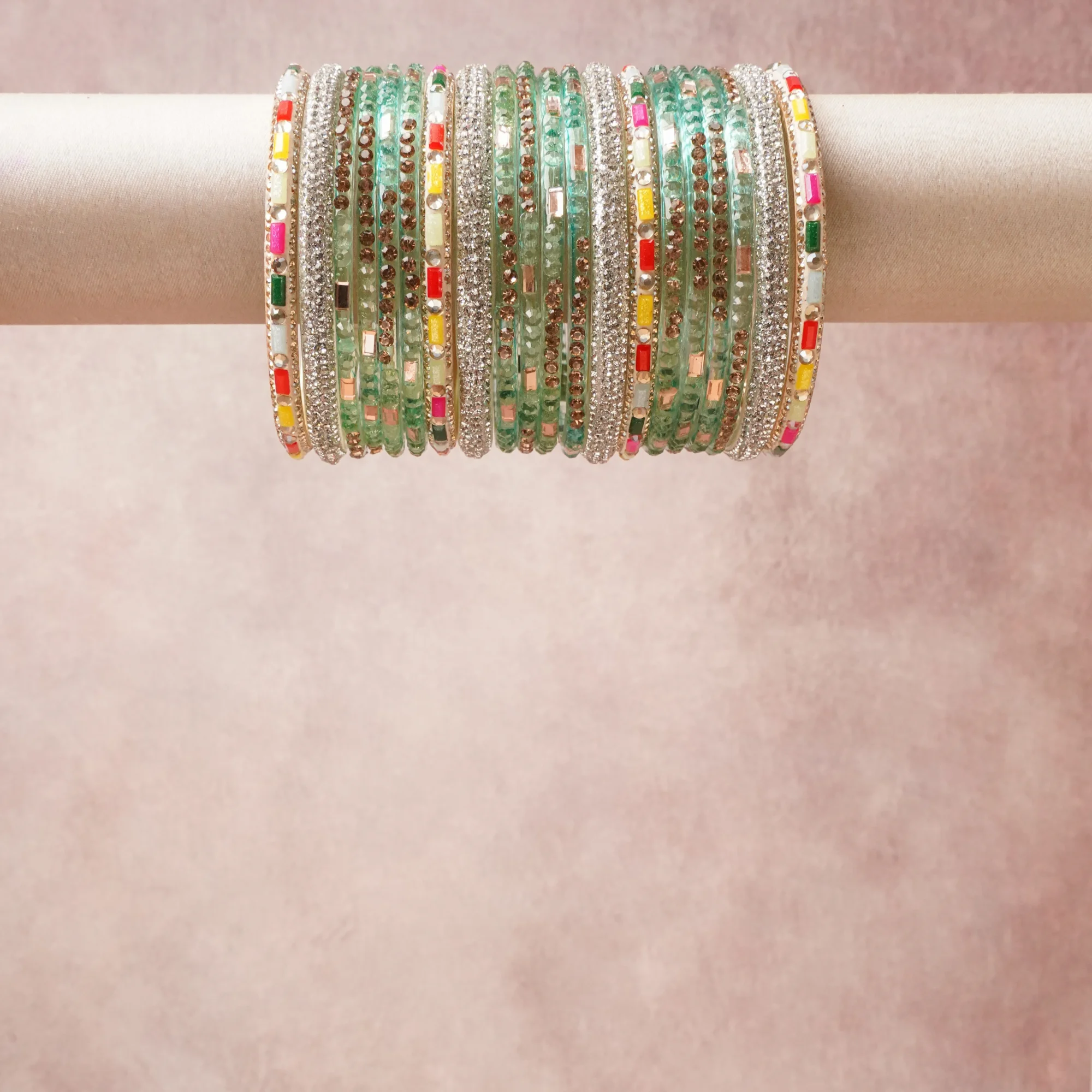 A grounding Mint Green forms the heart of the set, while touches of Ruby Red, Fuchsia Pink, Lemon Yellow, Sky Blue, Ivory add charm.

A thoughtful composition of Glass, Silver-toned Metal, Faceted Crystals, Enamel, Bronze-toned Metal, designed to feel complete without being heavy.
Each element layers seamlessly, creating a look that is refined, wearable and quietly striking.